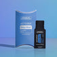 doTERRA Deep Blue Soothing Blend .25 mL black sample sachet standing beside its blue doTERRA pillow box on a glossy blue studio surface with soft reflections. doTERRA Deep Blue Essential Oil Sample (.25 mL)