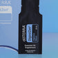 Close-up of the doTERRA DigestZen Digestive Blend .25 mL black sample sachet standing upright in front of its light blue pillow box on a blue background. doTERRA DigestZen Essential Oil Sample (.25 mL)