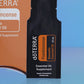 Close-up of the doTERRA Frankincense .25 mL black sample sachet standing upright in front of its orange pillow box on a blue background. doTERRA Frankincense Essential Oil Sample (.25 mL)