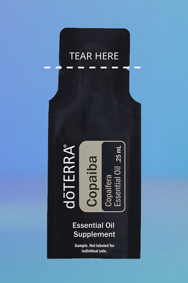 doTERRA Copaiba .25 mL sample sachet on a blue background with a dashed TEAR HERE line marking where to tear it open. doTERRA Copaiba Essential Oil Sample (.25 mL)