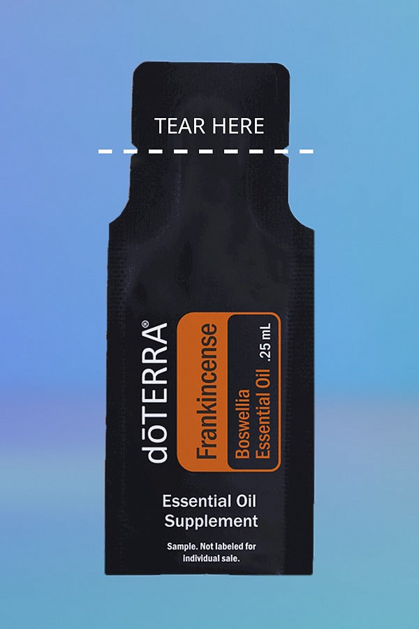 doTERRA Frankincense .25 mL sample sachet on a blue background with a dashed TEAR HERE line marking where to tear it open. doTERRA Frankincense Essential Oil Sample (.25 mL)