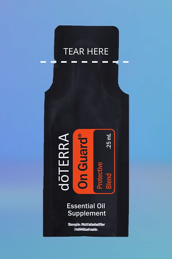 doTERRA On Guard Protective Blend .25 mL sample sachet on a blue background with a dashed TEAR HERE line marking where to tear it open. doTERRA On Guard Essential Oil Sample (.25 mL)