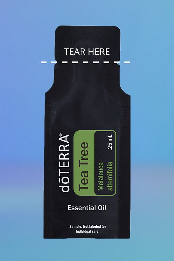 doTERRA Tea Tree .25 mL sample sachet on a blue background with a dashed TEAR HERE line marking where to tear it open. doTERRA Tea Tree Essential Oil Sample (.25 mL)