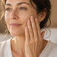 Woman applying doTERRA Frankincense to her cheek as part of her morning skincare routine. doTERRA Frankincense Essential Oil Sample (.25 mL)