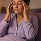 Woman in bed at night rubbing doTERRA Lavender onto her temples. doTERRA Lavender Essential Oil Sample (.25 mL)