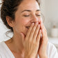 Woman in a sunny kitchen inhaling doTERRA Lemon from her cupped hands. doTERRA Lemon Essential Oil Sample (.25 mL)