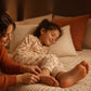 Mother rubbing doTERRA On Guard into the soles of her sleepy child's feet at bedtime. doTERRA On Guard Essential Oil Sample (.25 mL)