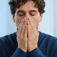 Young man at his desk inhaling doTERRA Peppermint from his cupped hands. doTERRA Peppermint Essential Oil Sample (.25 mL)