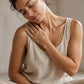 Woman on a yoga mat massaging doTERRA Copaiba into her neck and shoulder by a sunny window. doTERRA Copaiba Essential Oil Sample (.25 mL)