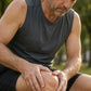 Man in running clothes rubbing doTERRA Deep Blue into his knee on a park bench after a run. doTERRA Deep Blue Essential Oil Sample (.25 mL)