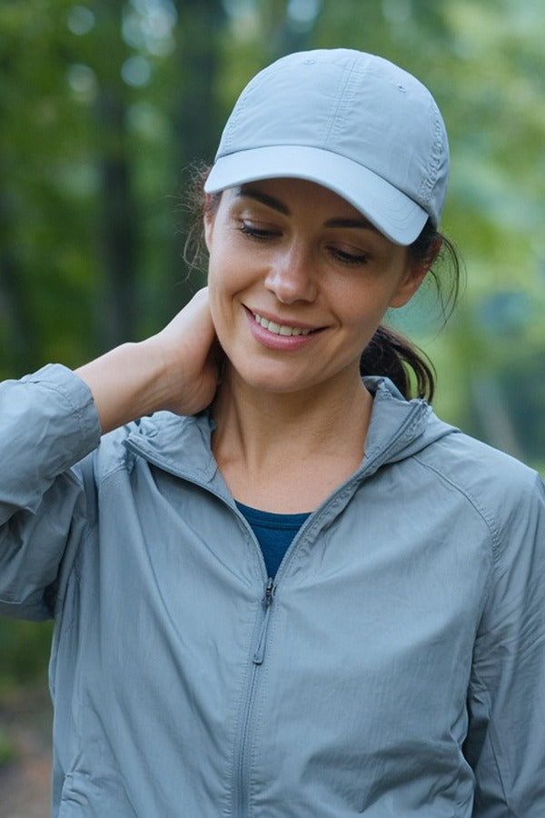 Woman on a trail after a run rubbing doTERRA Peppermint onto the back of her neck. doTERRA Peppermint Essential Oil Sample (.25 mL)