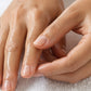 Hands massaging doTERRA Tea Tree into the fingernails and cuticles over a white towel. doTERRA Tea Tree Essential Oil Sample (.25 mL)