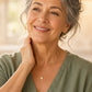 Woman in a bright kitchen rubbing doTERRA Wild Orange onto the back of her neck. doTERRA Wild Orange Essential Oil Sample (.25 mL)
