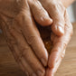 Older hands rubbing a drop of doTERRA Copaiba oil between the palms over a wooden table. doTERRA Copaiba Essential Oil Sample (.25 mL)