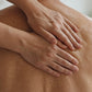 Hands massaging doTERRA Deep Blue into an older man's shoulder blades in a bright living room. doTERRA Deep Blue Essential Oil Sample (.25 mL)