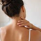 Woman rubbing doTERRA Lemon into the back of her neck in a bright bathroom. doTERRA Lemon Essential Oil Sample (.25 mL)