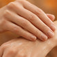 Hands rubbing doTERRA On Guard into the wrist against a warm autumn background. doTERRA On Guard Essential Oil Sample (.25 mL)