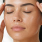 Woman massaging doTERRA Peppermint into her temples with her fingertips. doTERRA Peppermint Essential Oil Sample (.25 mL)