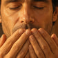 Man inhaling doTERRA Wild Orange from his cupped hands in warm golden light. doTERRA Wild Orange Essential Oil Sample (.25 mL)