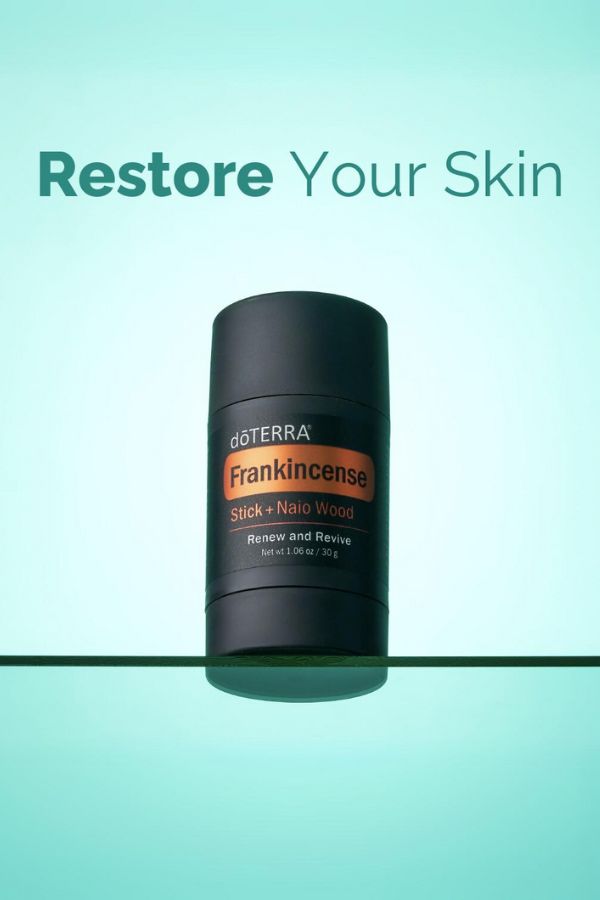 A doTERRA Frankincense Stick + Nail Wood deodorant stick on a reflective teal surface with the text 'Restore Your Skin' above it.
