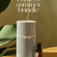White diffuser and doTERRA essential oil bottle on a wooden surface with green leaves in the background, featuring 'endless summer bundle' text.