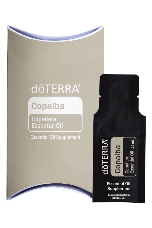 doTERRA Copaiba .25 mL black sample sachet standing in front of its taupe doTERRA pillow box on a white background. doTERRA Copaiba Essential Oil Sample (.25 mL)