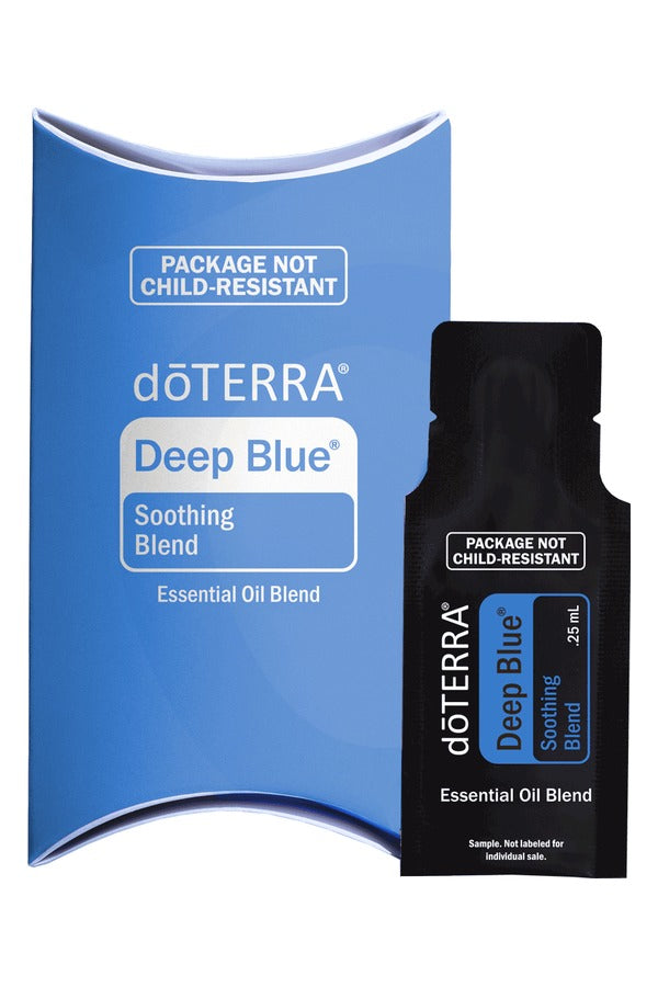 doTERRA Deep Blue Soothing Blend .25 mL black sample sachet standing in front of its blue doTERRA pillow box on a white background. doTERRA Deep Blue Essential Oil Sample (.25 mL)