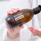 Woman pouring doTERRA Castor Oil into her hand for the Detox Bundle evening routine