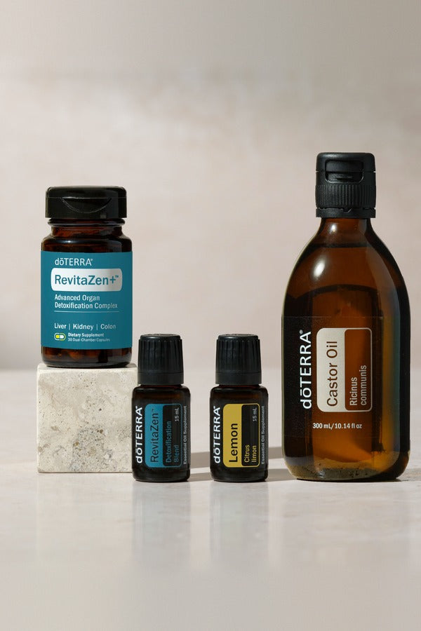 doTERRA Detox Bundle products arranged on a stone block in soft daylight