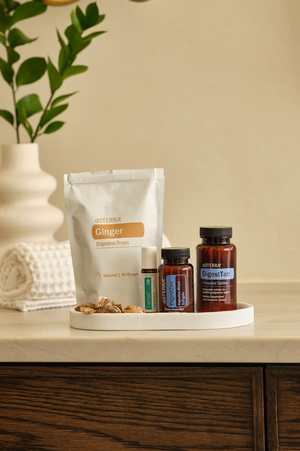 doTERRA Digestive Bundle with Ginger Drops, DigestTab, DigestZen Softgels and Tamer on a bathroom counter