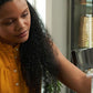 Woman mixing a doTERRA MetaPWR Advantage stick pack into a glass of water at her table