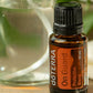 doTERRA On Guard Protective Blend bottle beside a glass of water
