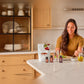 Woman preparing a healthy meal in her kitchen with the doTERRA Metabolic Health Bundle