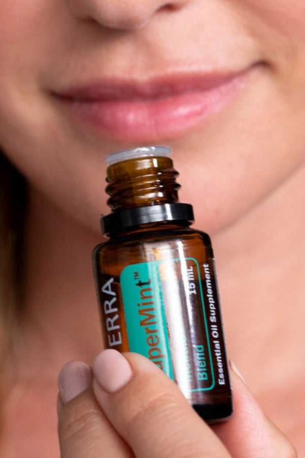 Woman enjoying the invigorating aroma of doTERRA SuperMint essential oil blend