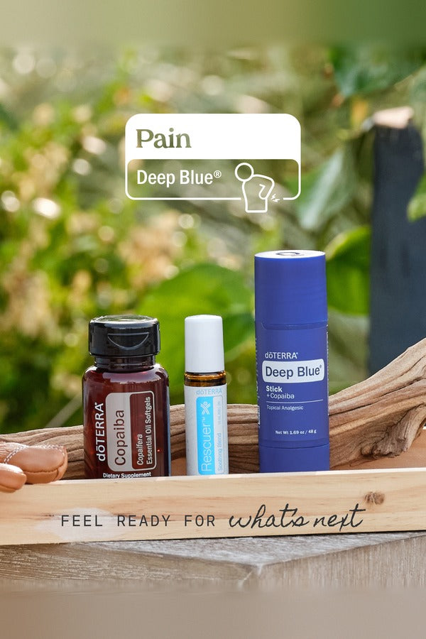 doTERRA Pain Bundle with Copaiba Softgels, Rescuer and Deep Blue Stick on a garden table