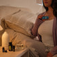 Woman relaxing on her couch with the doTERRA Respiratory Bundle in the evening
