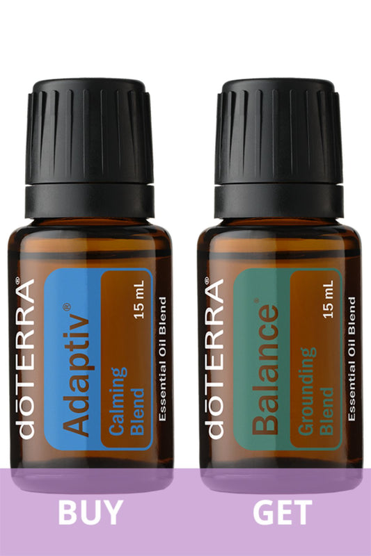 Two doTERRA essential oil bottles shown side by side on a white background with a purple banner at the bottom reading BUY and GET. The left bottle is doTERRA Adaptiv Calming Blend and the right bottle is doTERRA Balance Grounding Blend, both 15 mL amber bottles with black caps.
