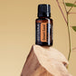 doTERRA Desert Sand essential oil bottle on a wooden surface with a natural background