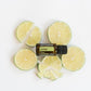 A bottle of doTERRA Lime essential oil surrounded by fresh lime slices on a clean white background.