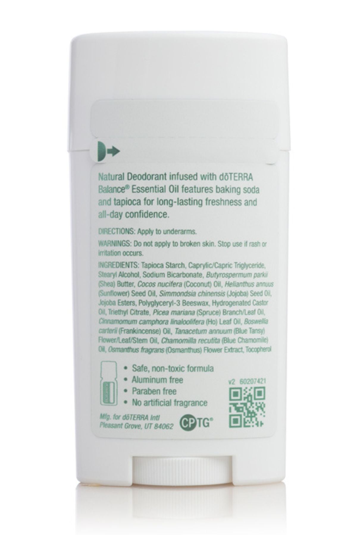 A white cylindrical deodorant stick container with printed green and black text on the back, photographed on a clean white background with a soft reflection below.