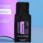 A black doTERRA Serenity Restful Blend essential oil blend sample sachet standing upright in front of a purple and blue branded box. doTERRA Serenity Essential Oil Sample (.25 mL)