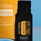 A black doTERRA Wild Orange citrus slice essential oil supplement sachet in front of a yellow-orange doTERRA box on a blue gradient background. doTERRA Wild Orange Essential Oil Sample (.25 mL)